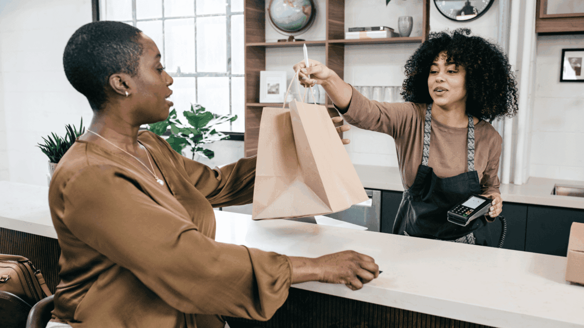 Cashier delivering her purchase to a customer as an example of speed of service.