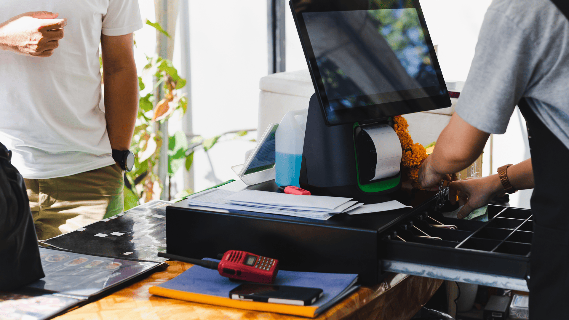 Image of a client and a cashier handling management as a representation of loss prevention.