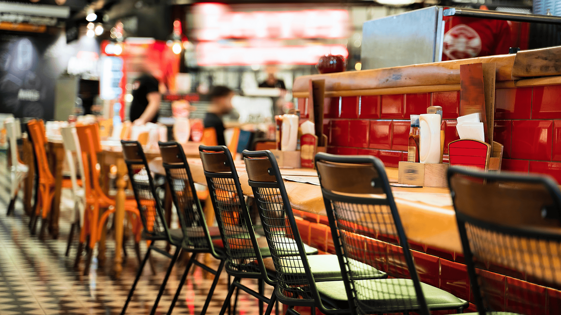 Perspective view of chairs and tables in a restaurant to illustrate QSR franchise opportunities.