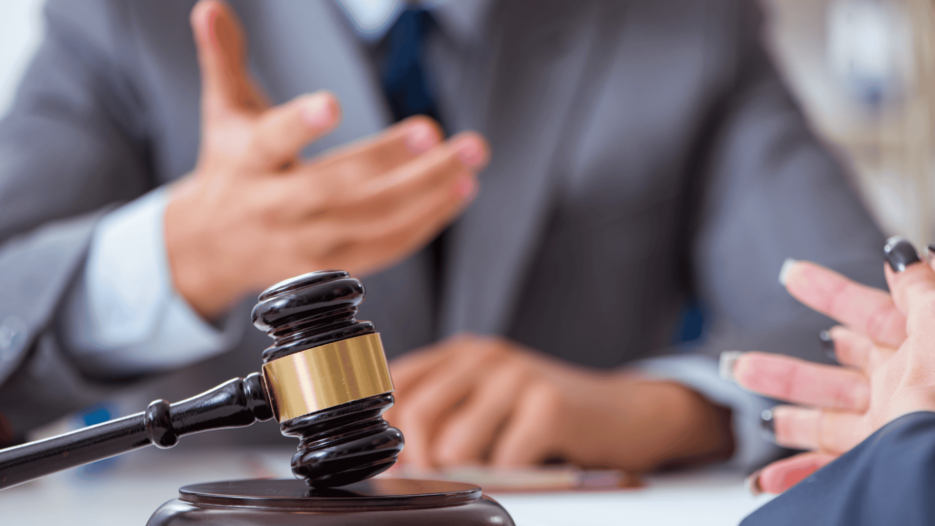 Photograph of a woman and a man (with a judge's gavel in front of them) representing case management.