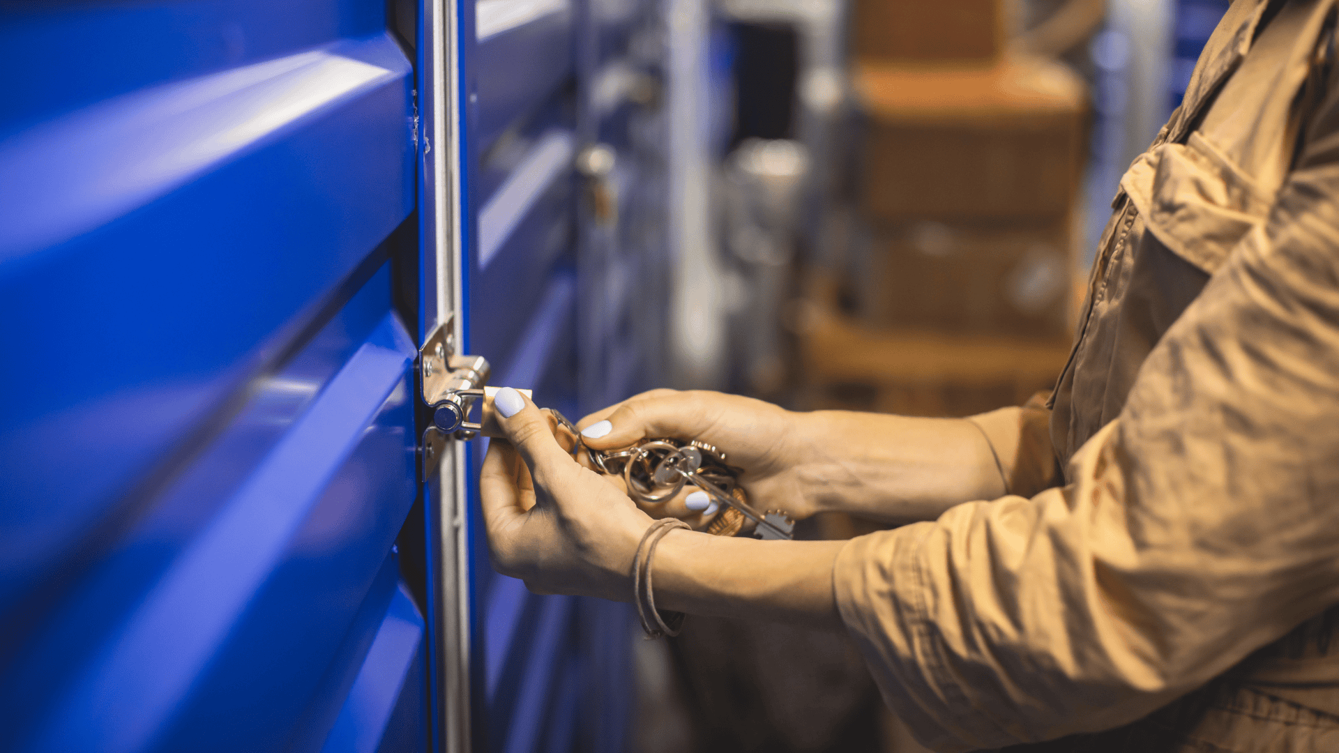 Photograph of a woman locking a warehouse with a padlock on a chain as an example of asset protection.