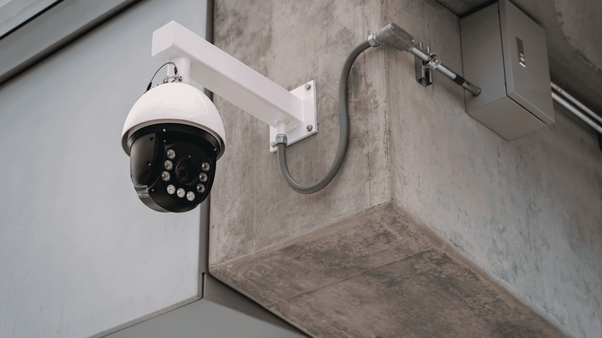 Picture of a installed wired camera (or IP Camera) on a concrete structure.