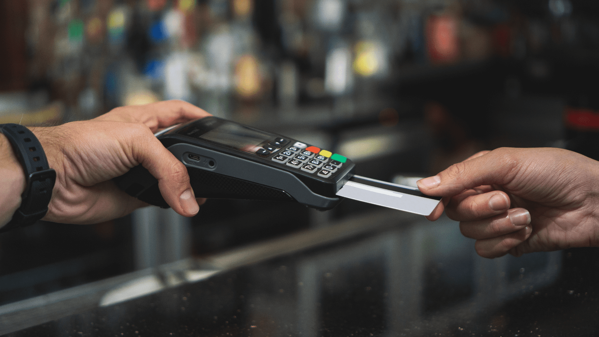 Image of a credit card transaction at a terminal to demonstrate part of the transaction monitoring process.