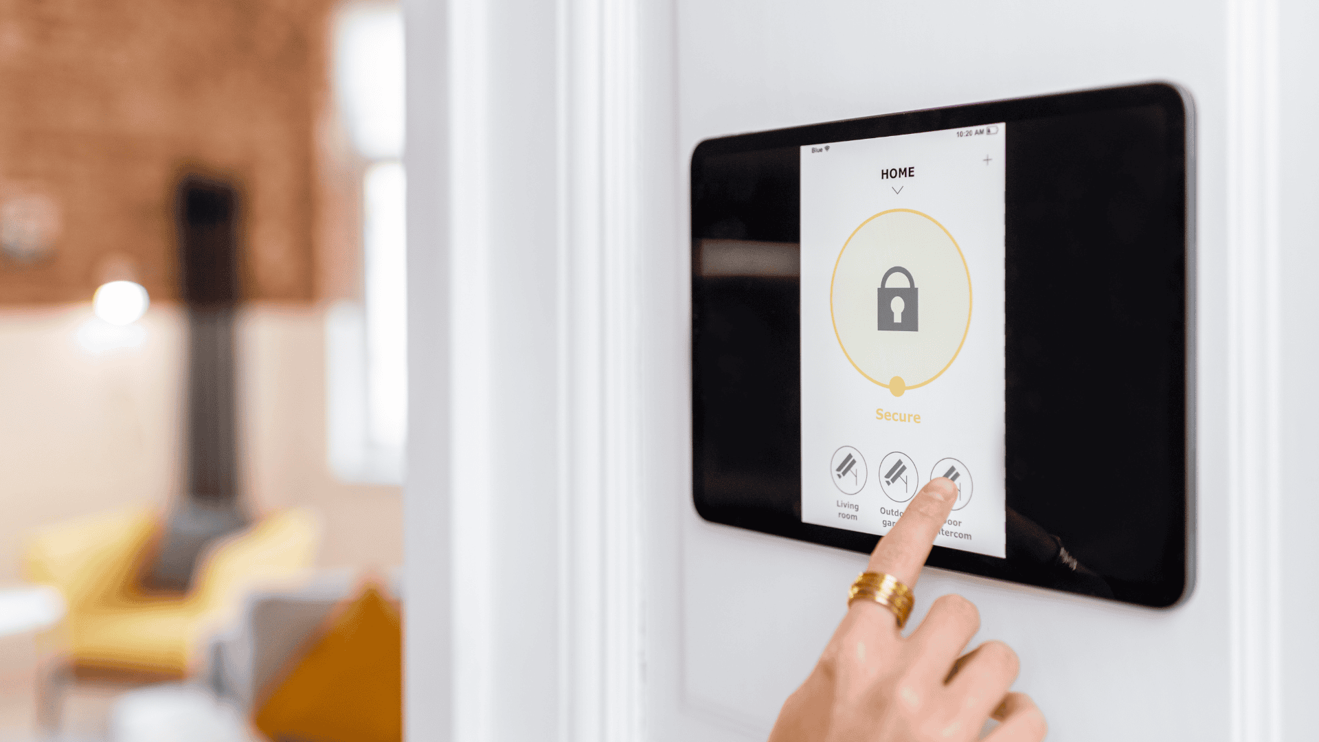 Image of a woman's hand configuring the alarm system using a touch screen.