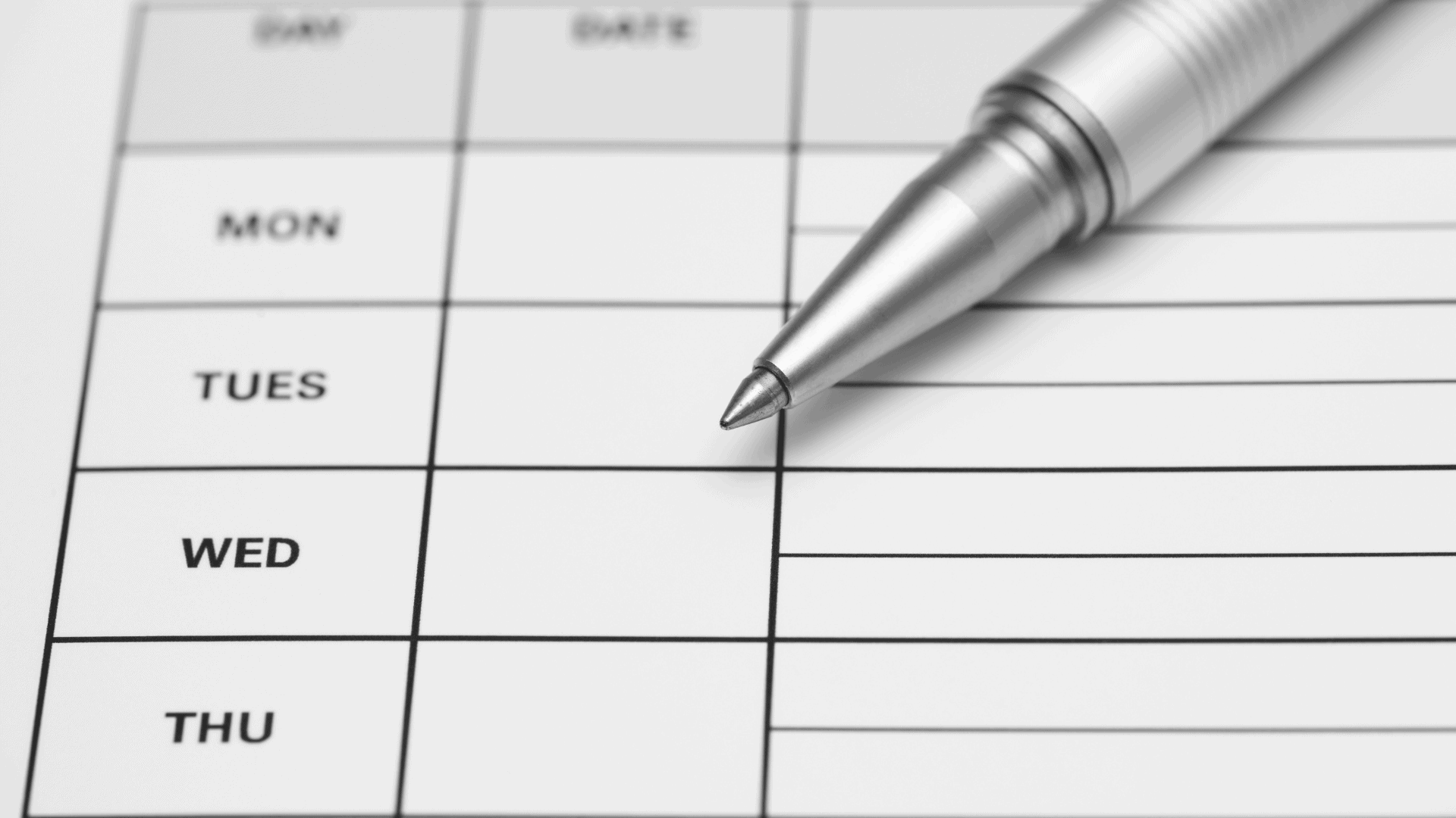 Sheet of paper with a grid listing the days of the week, a basic example of time and attendance systems.