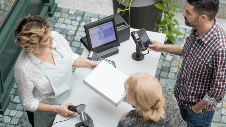 Two customers and a cashier as an example of service efficiency in retail.