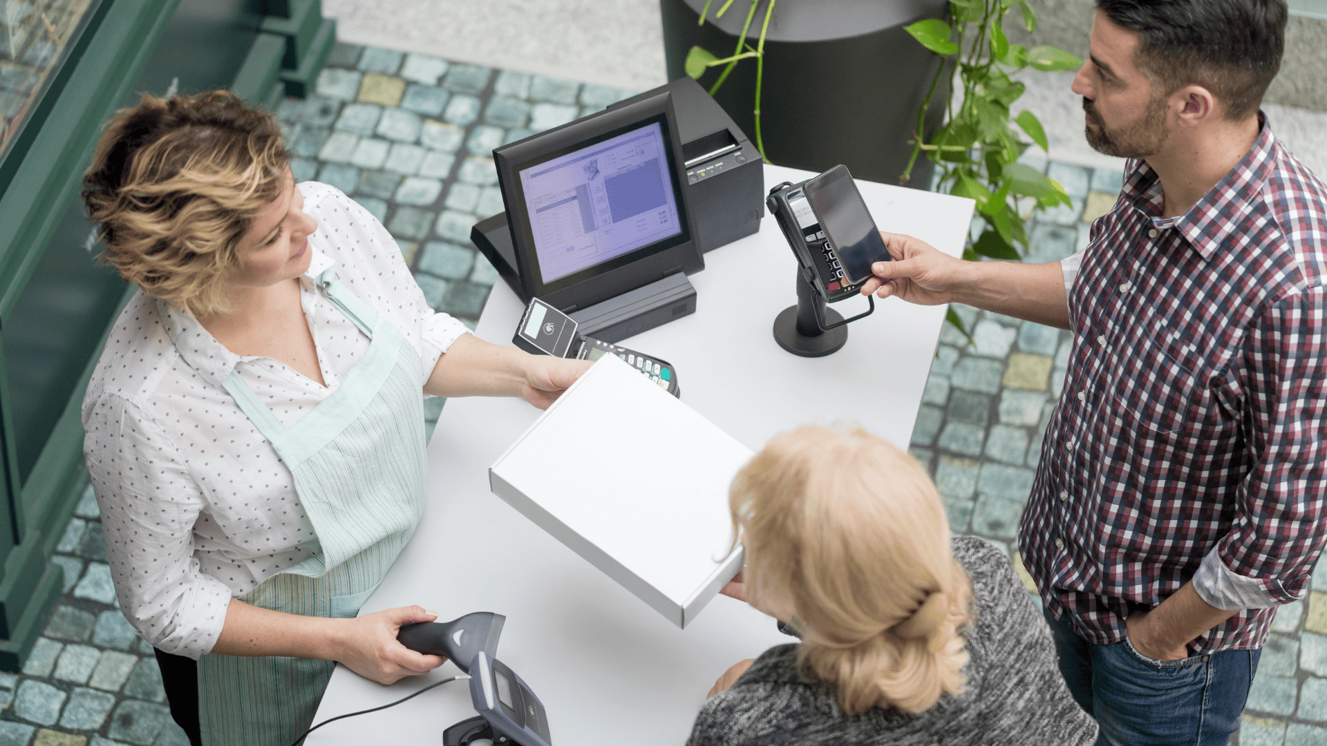 Two customers and a cashier as an example of service efficiency in retail.