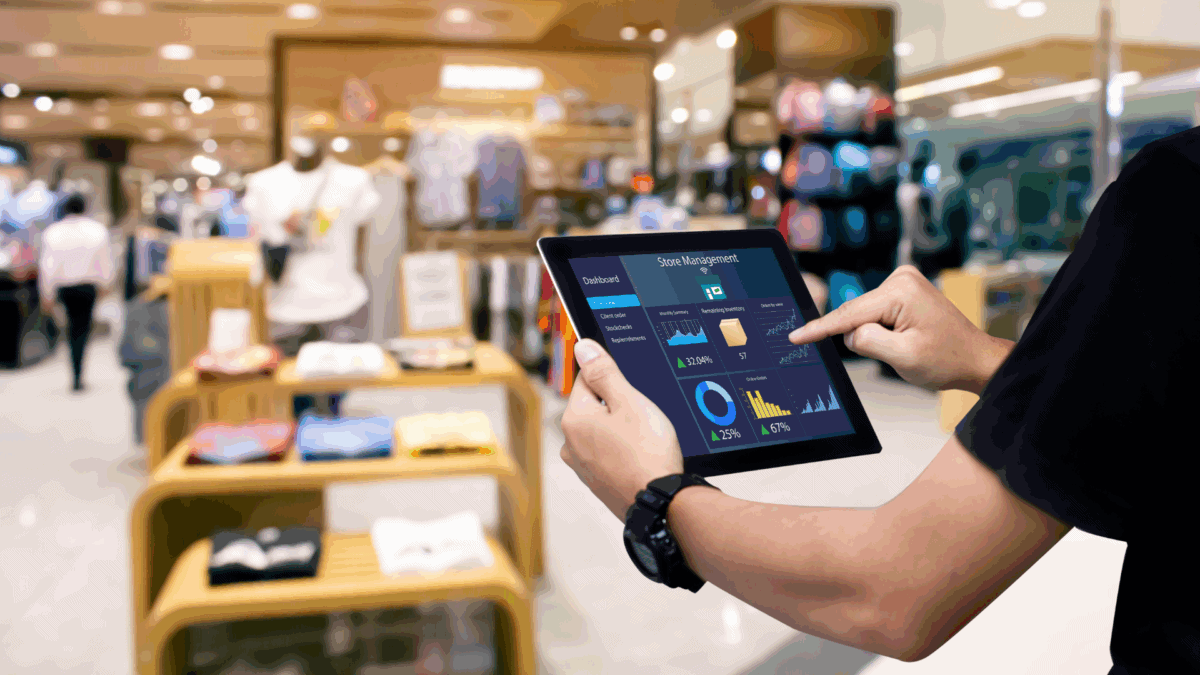 A retail manager uses a tablet with sales data, illustrating average retail sales Per square foot.