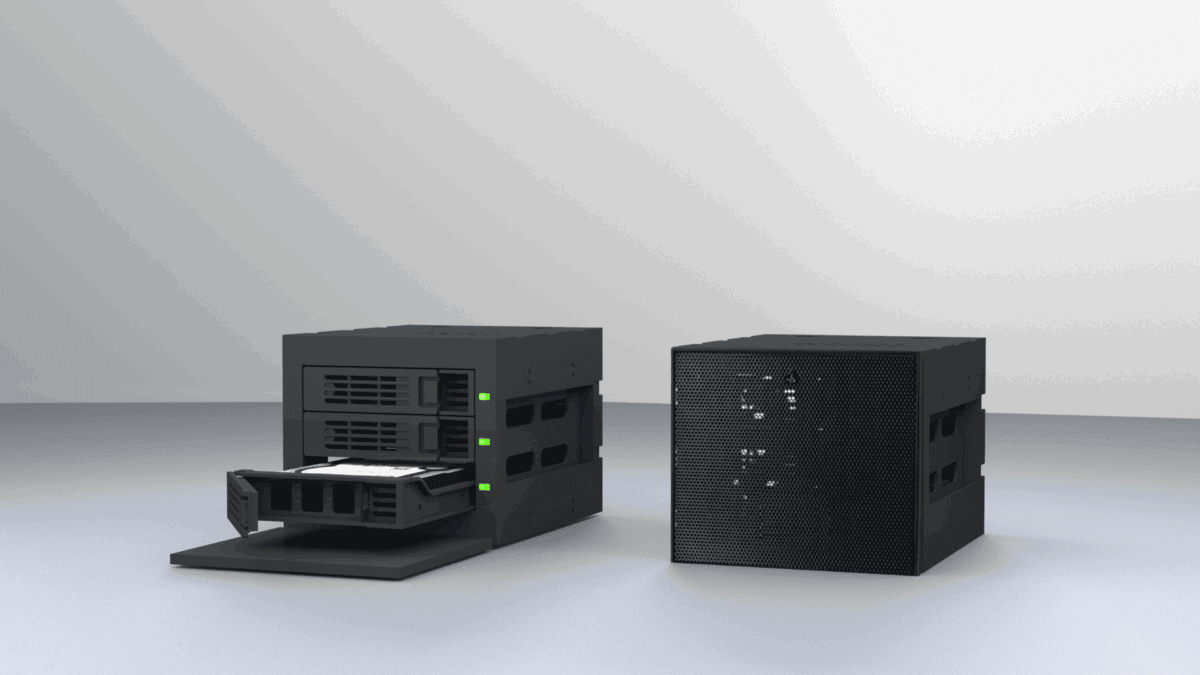 Two sleek, black network-attached storage (NAS) devices are displayed on a minimalist surface, one with a drive tray partially extended, representing options for the best network-attached storage solutions.