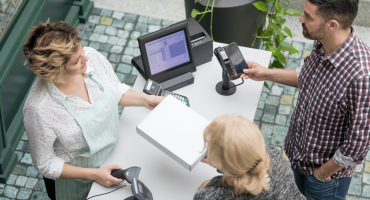 Two customers and a cashier as an example of service efficiency in retail.